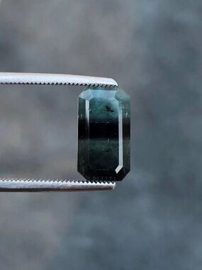 3.72 carats genuine emerald cut bi tourmaline  loose in gem jar.